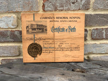 Birth certificates printed on wood.
