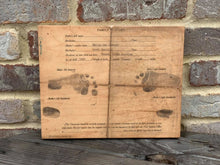 Birth certificate printed on wood.