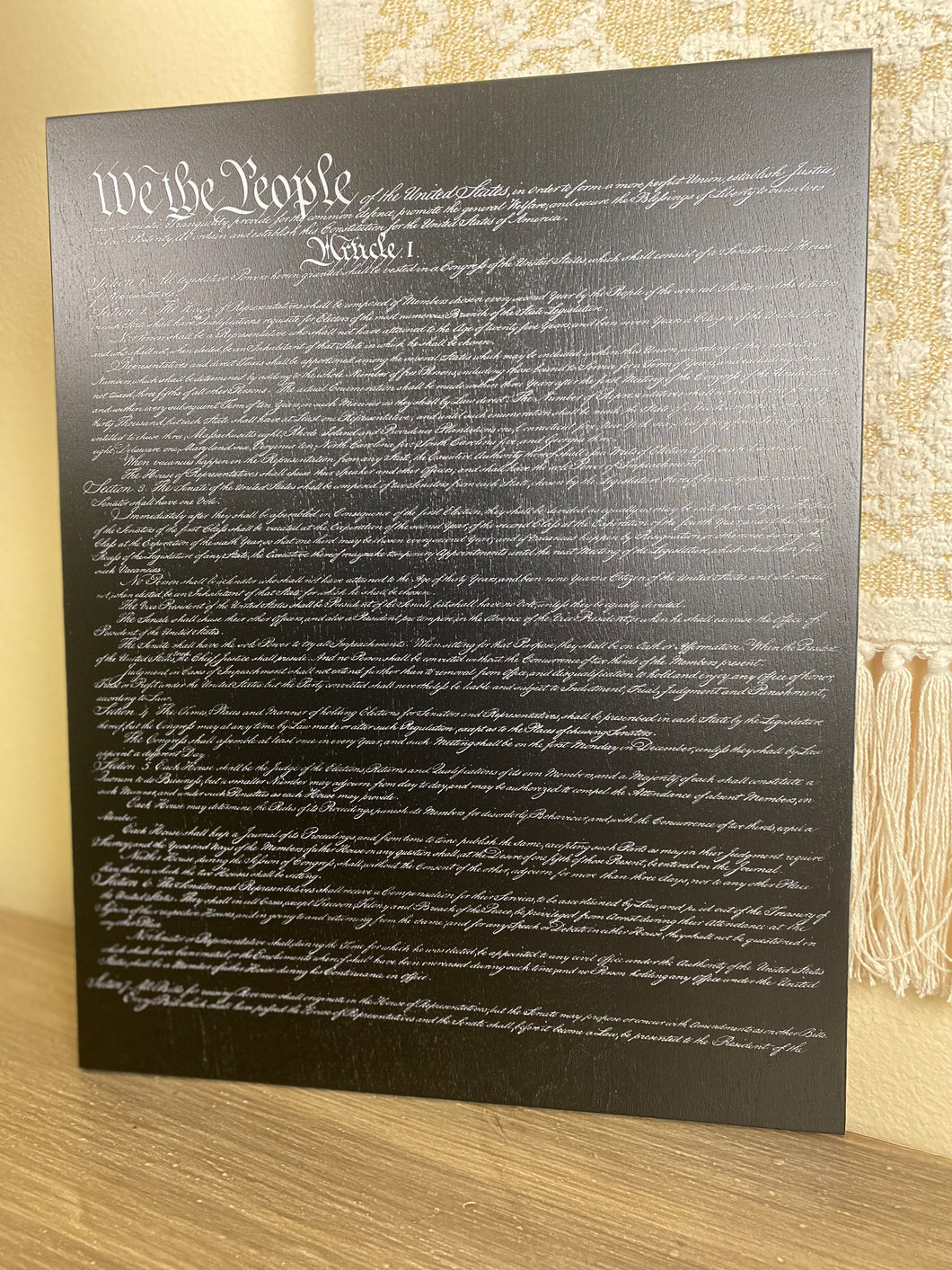 The Constitution of the United States of America printed on wood.