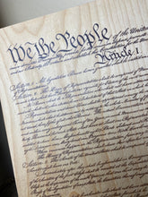The Constitution of the United States of America printed on wood.